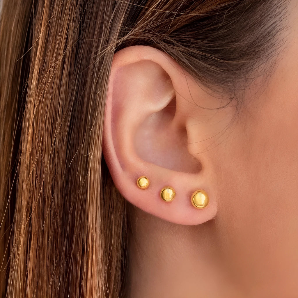 Stainless steel round ball stud earrings on a white background, showing gold and silver plated options.