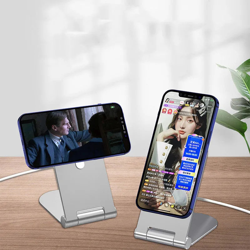 Silver vertical adjustable magnetic phone bracket for iPhone 12 on a flat surface.