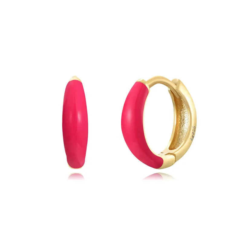 Geometric epoxy resin earrings with dripping oil colour technique showing oval curves and integrated rings