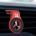 Black magnetic car air vent phone holder with adjustable clip and perfume slice attached