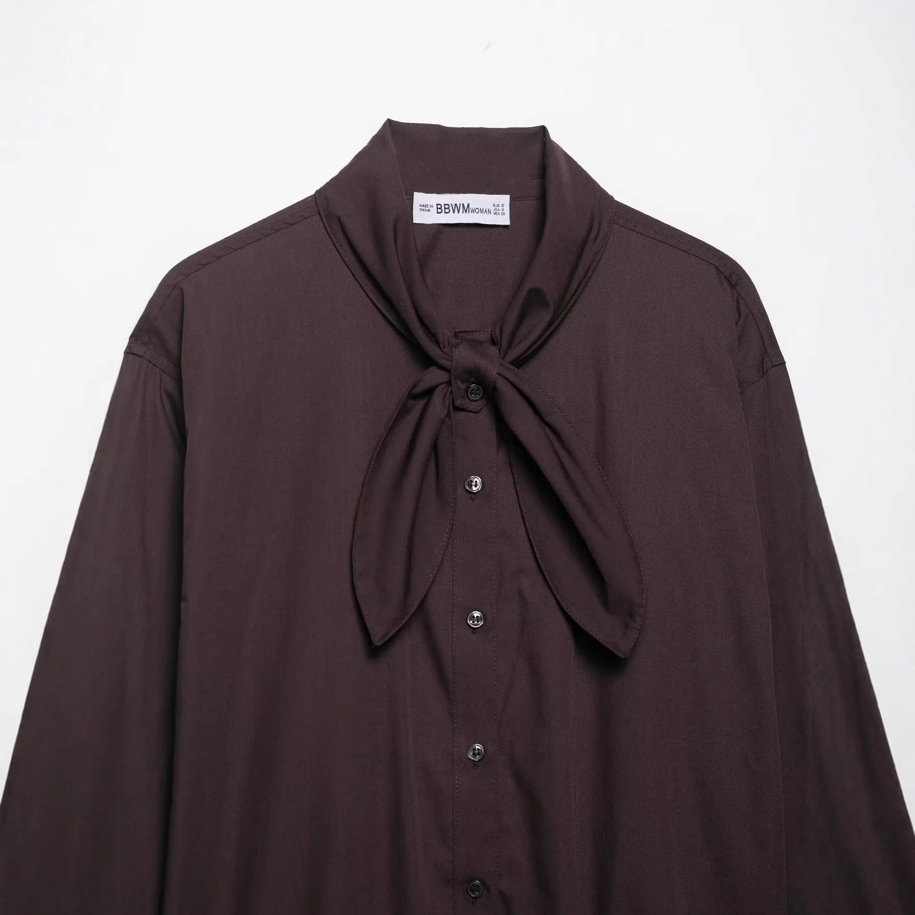 Brown women's loose fit poplin shirt with long sleeves and a scarf bow tie detail.