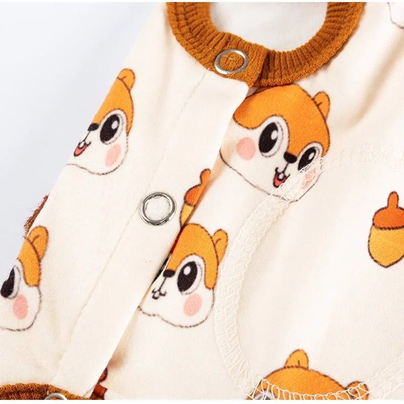 Small dog wearing Chip 'n' Dale themed cream onesie with yellow trim and embroidered acorn pocket