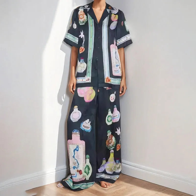 Women's black casual set with cartoon print, featuring a long-sleeve cardigan and matching trousers