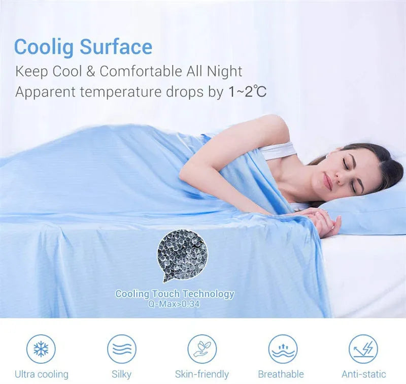 Blue Japanese cooling blanket with Q-Max fibres laid flat on a bed.