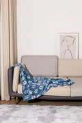 Blue cartoon dog pattern double-sided flannel pet blanket shown in a dog crate.