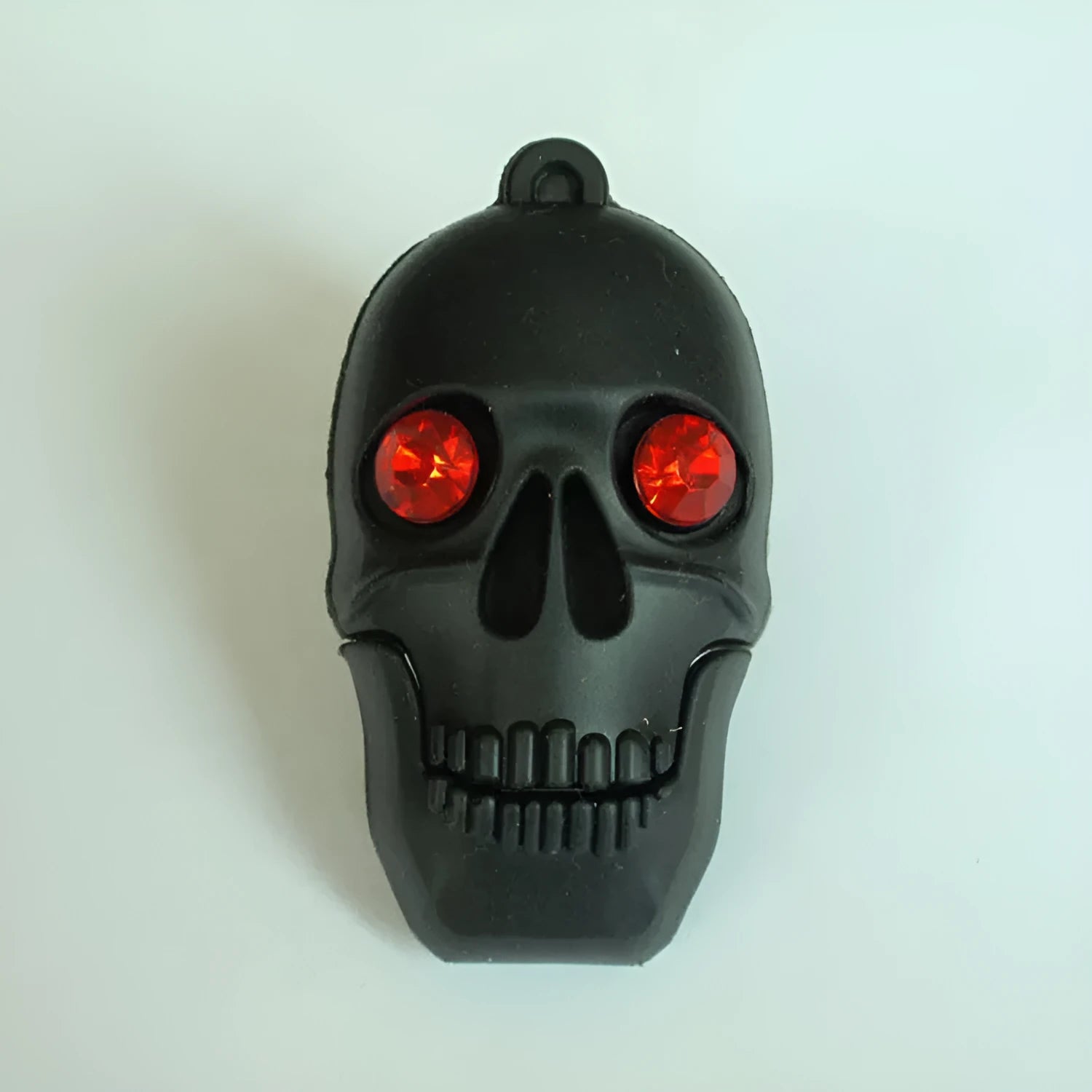 Skeleton skull shaped USB flash drive on a small metal chain with PVC shell.