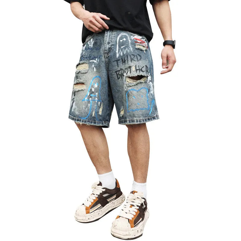 Blue ripped men's denim shorts with graffiti pattern and straight-leg cut.