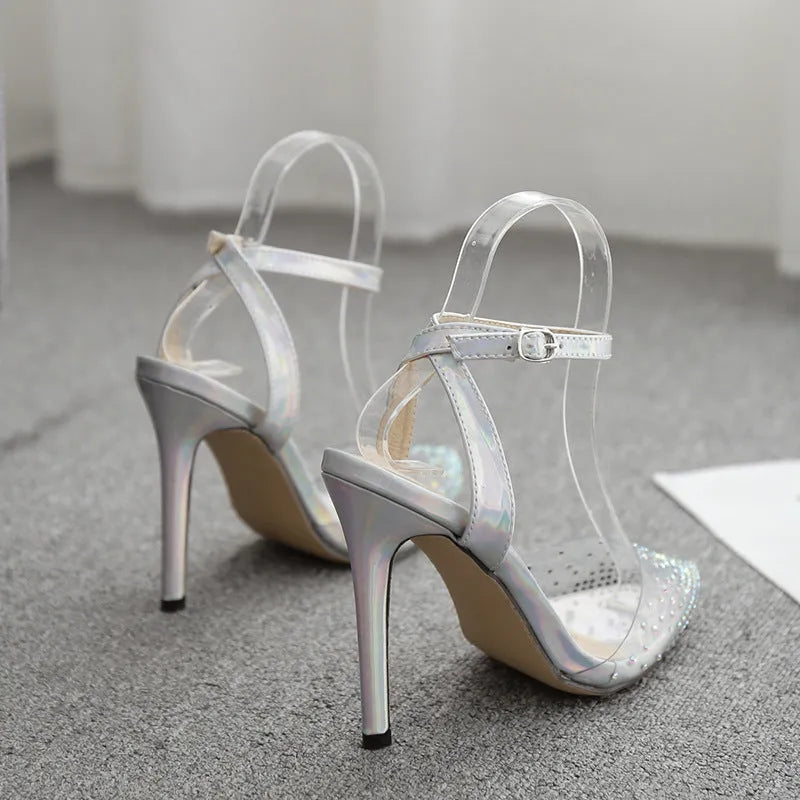 Women's clear PVC pointed toe sandals with a stiletto heel on a white background.