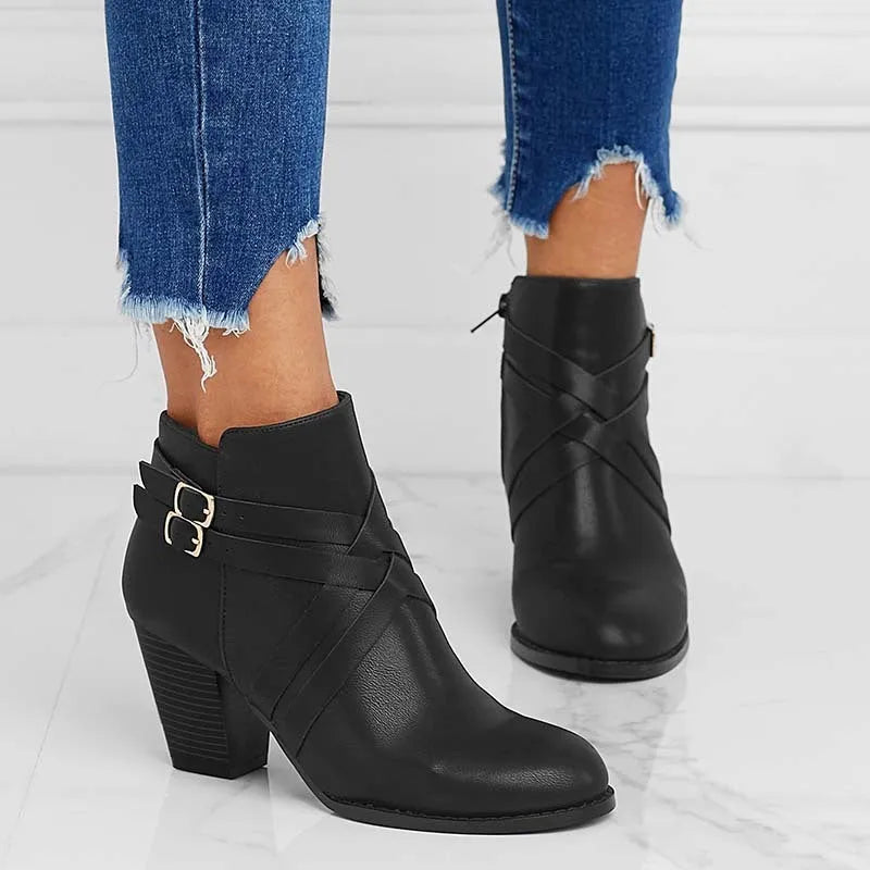 Women's black short boots with a 7cm stout heel and side zip fastener on a rubber sole.