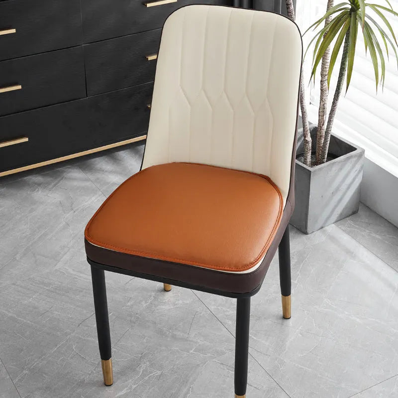 Horseshoe-shaped PU leather seat cushion in orange, shown on a chair.