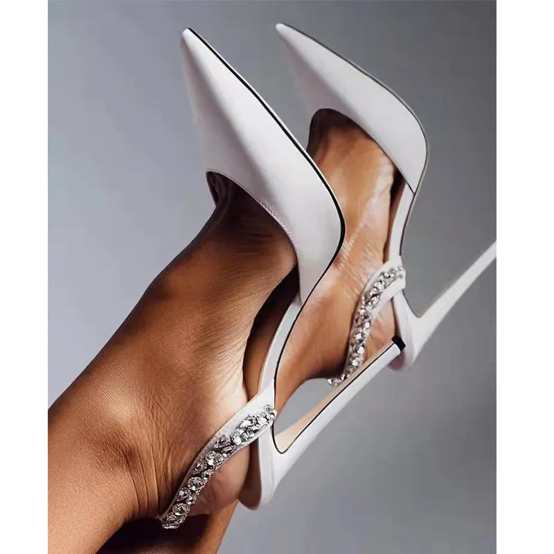 Women's black patent leather rhinestone high heel sandals with pointed toe and ankle strap.