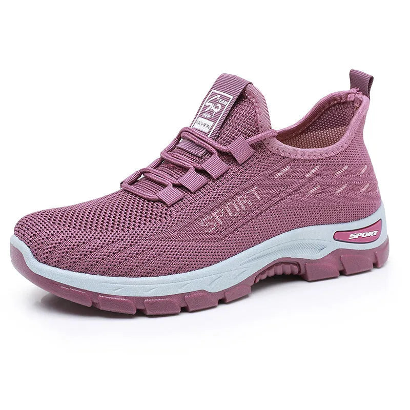 Men's and women's casual low-top sneakers with a soft PVC sole in black, red, light purple, grey, and brown.
