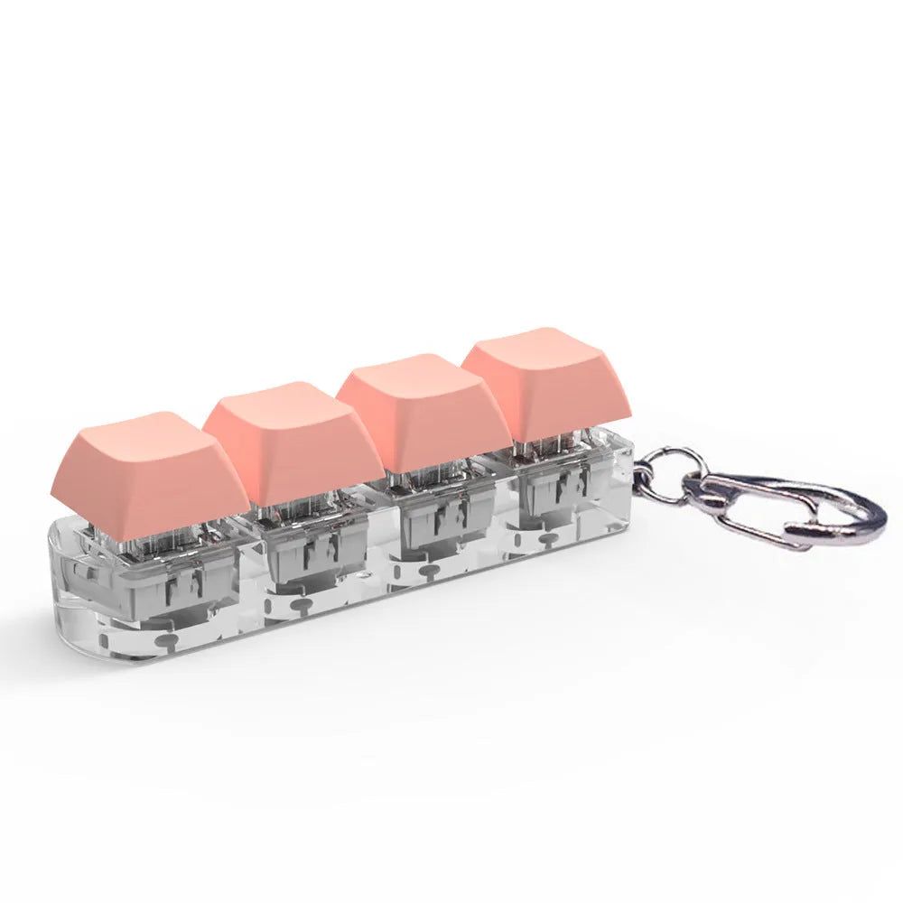 Four-key mechanical keyboard switch tester made of ABS plastic on a desk.