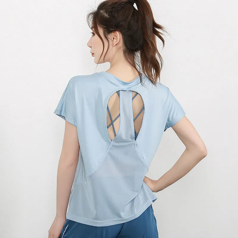 Women's short sleeve polyester fitness t-shirt in pink, shown for sports and gym wear.
