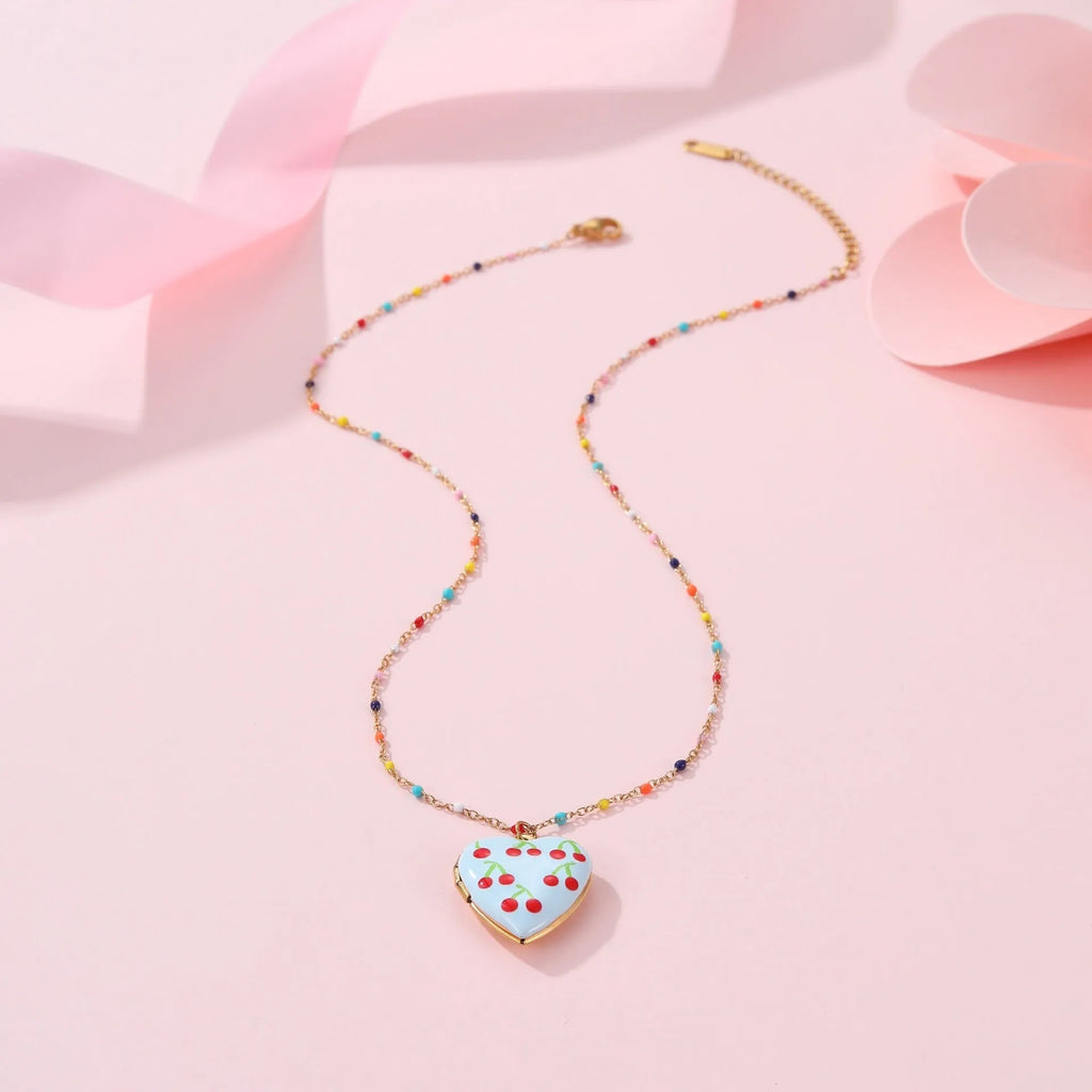 Stainless steel fruit pendant necklace with gold plating showing heart and fruit charm designs on adjustable chain