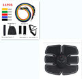 Black EMS muscle stimulator with electrode pads placed on abdomen for slimming and toning