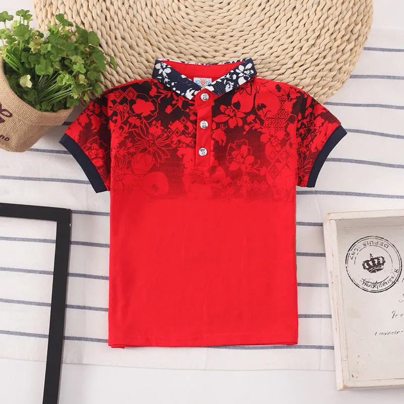 Boys short sleeve cotton T-shirt in navy blue with a lapel collar, laid flat.