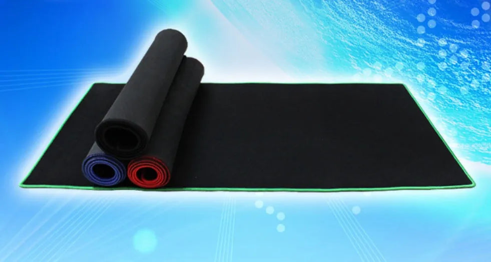 Oversized rubber mouse pad 30x60cm with stitched edges, black colour, on a desk with keyboard and mouse