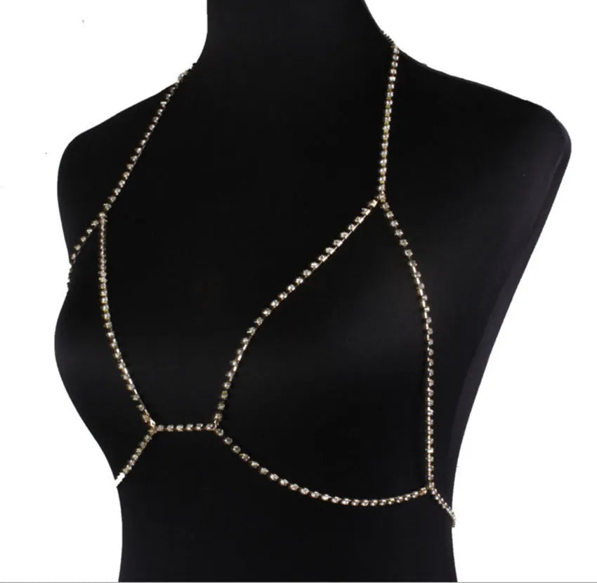Women's rhinestone metal body chain necklace in gold on a model showing torso wear