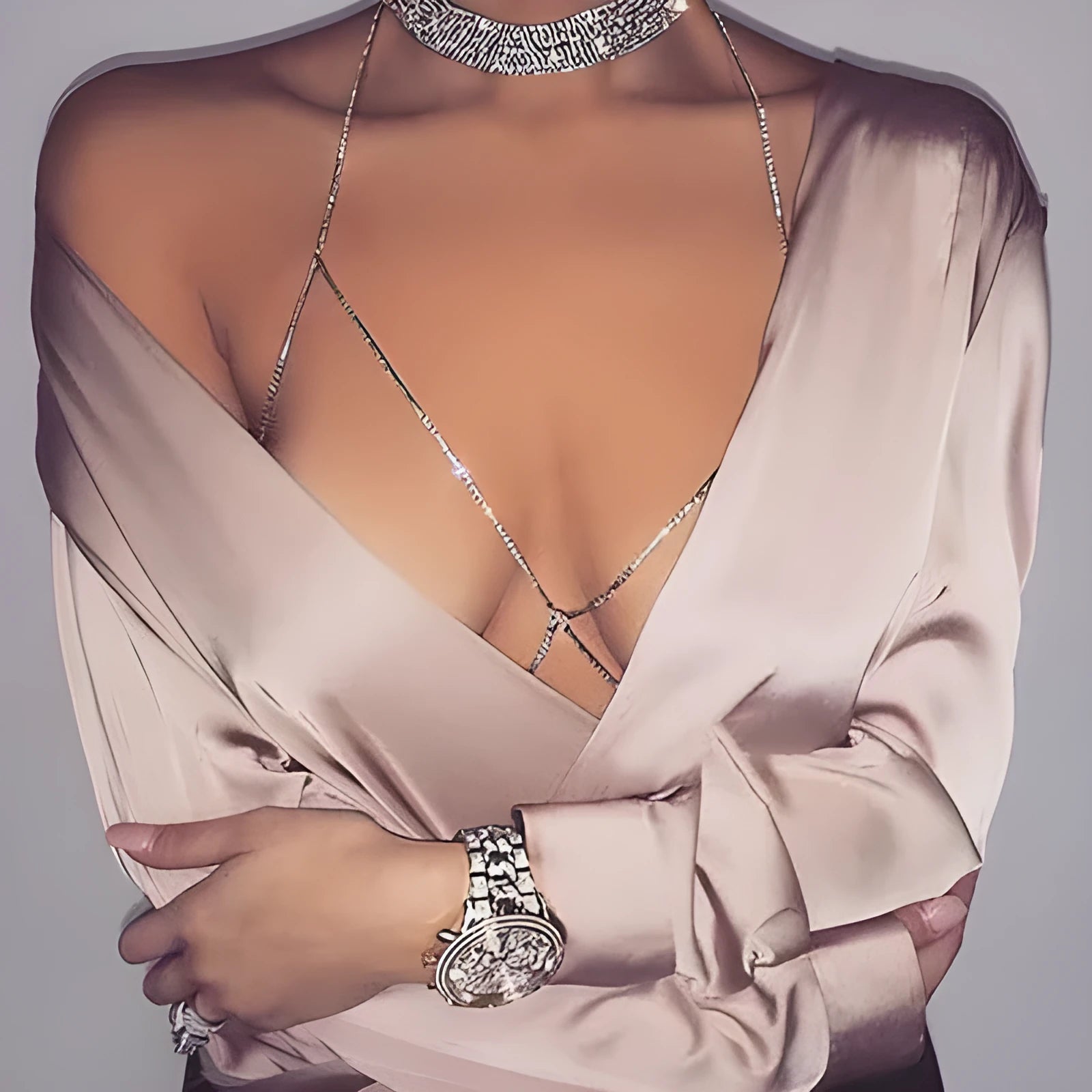 Women's rhinestone metal body chain necklace in gold on a model showing torso wear