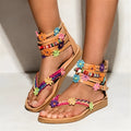 Ethnic beaded petal and flower decoration on artificial PU Roman sandals with a round toe.