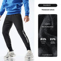 Man wearing black air layer ankle-tied sweatpants with mid waist, made from polyester and spandex blend.
