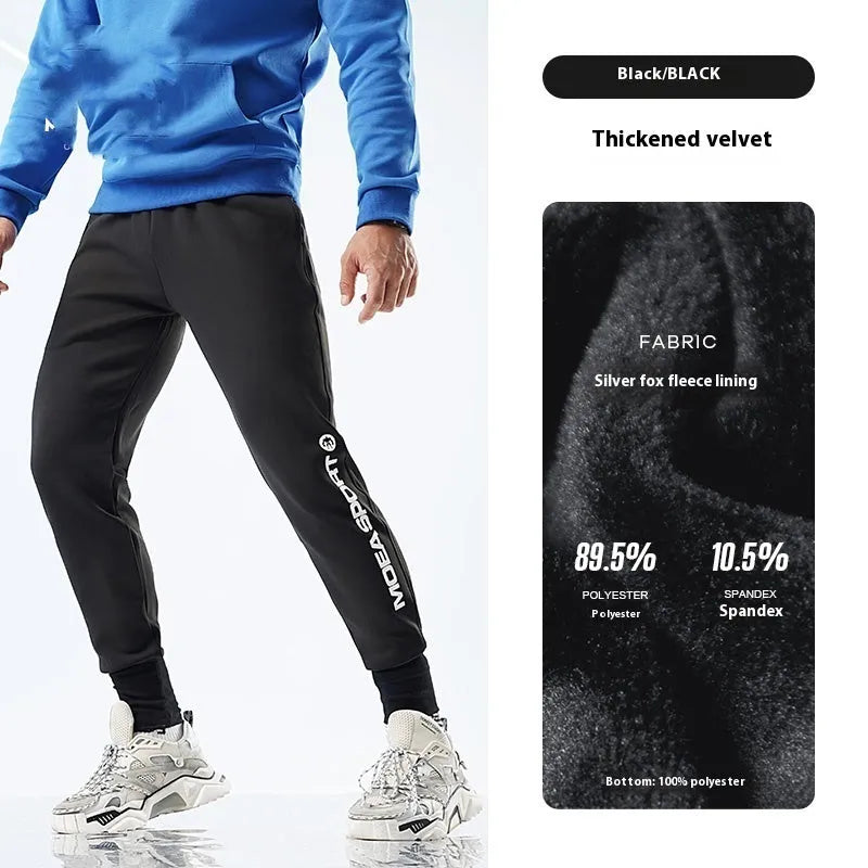 Man wearing black air layer ankle-tied sweatpants with mid waist, made from polyester and spandex blend.