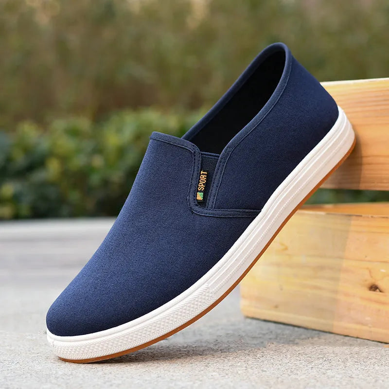 Men's black and blue canvas slip-on shoes with round toe design and composite soles