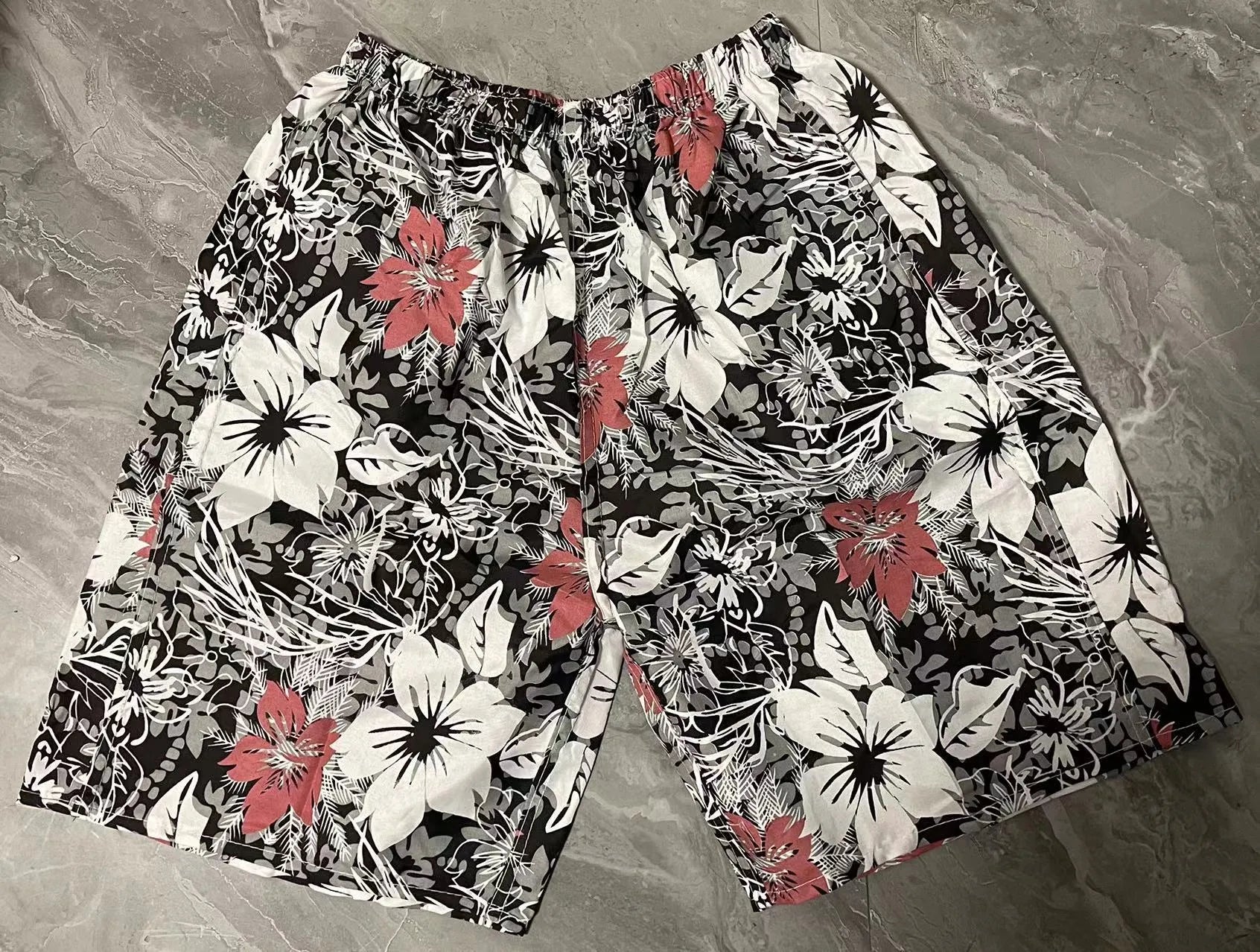 Men's floral print five-point swimming trunks made from polyester in a free size.
