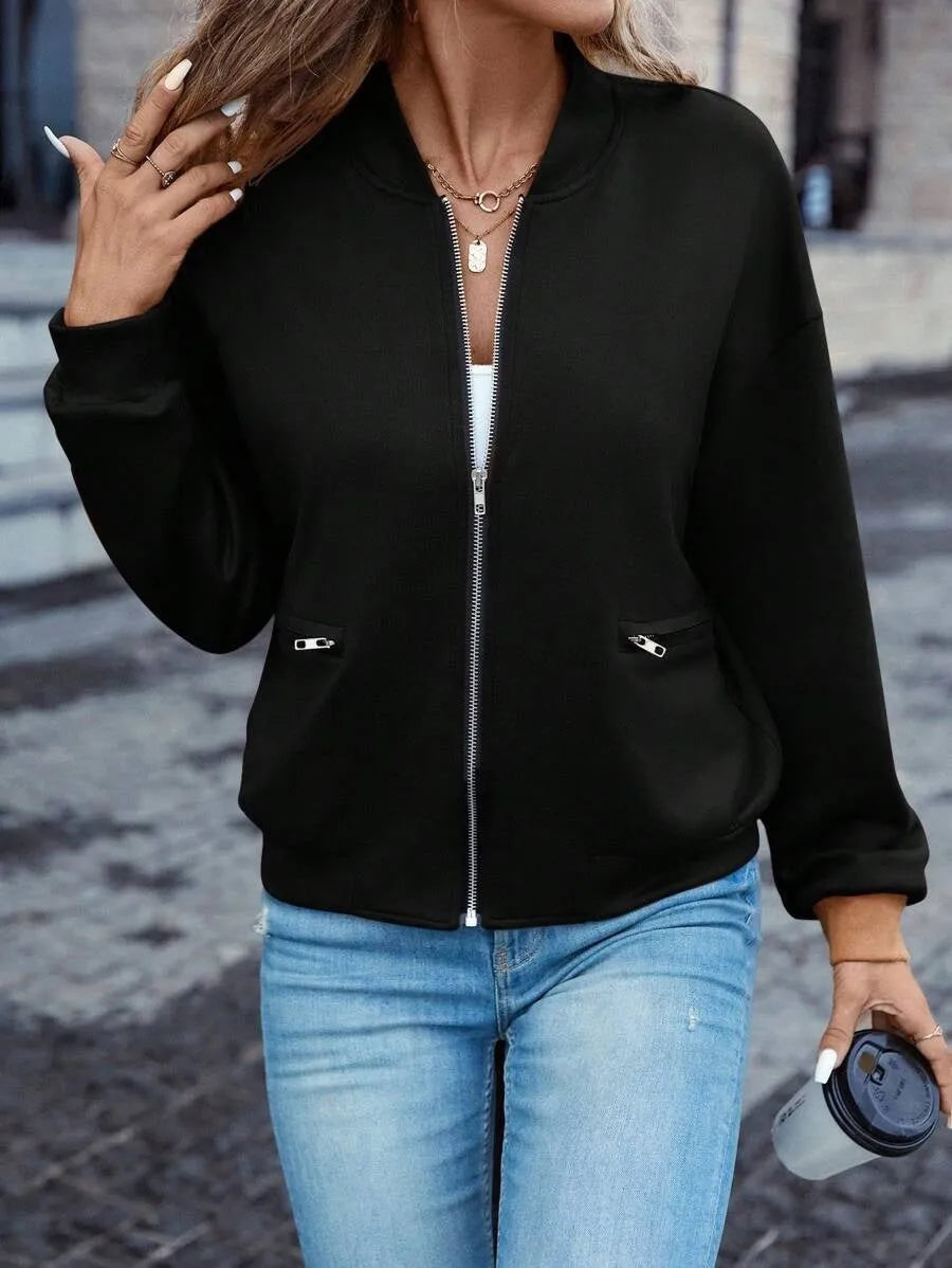 Women's solid black polyester zip jacket with long sleeves and faux pockets