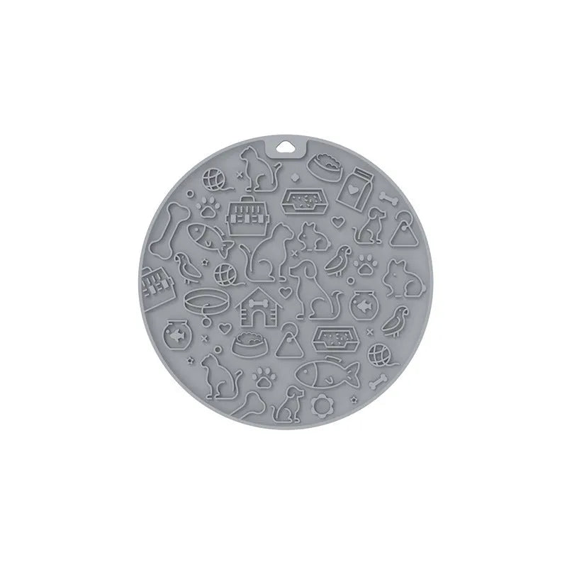 Round silicone pet licking mat with suction cup base in blue colour on a floor.