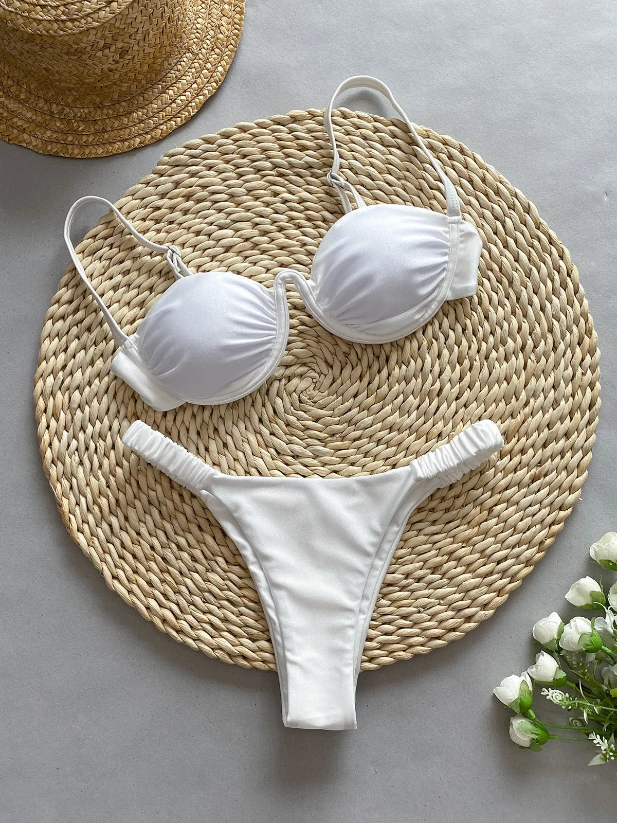 Women's black underwire bikini swimsuit on a mannequin, showing brief style and supportive fit.