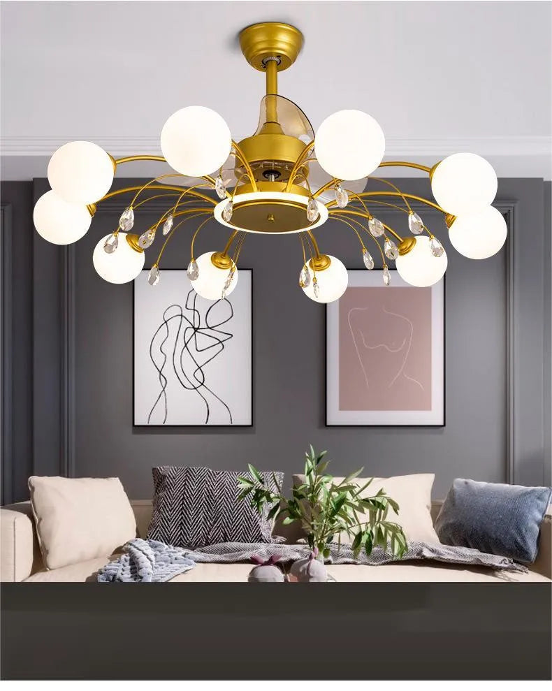 Gold finish ceiling fan chandelier with multiple lights and metal blades, shown installed in a living room.