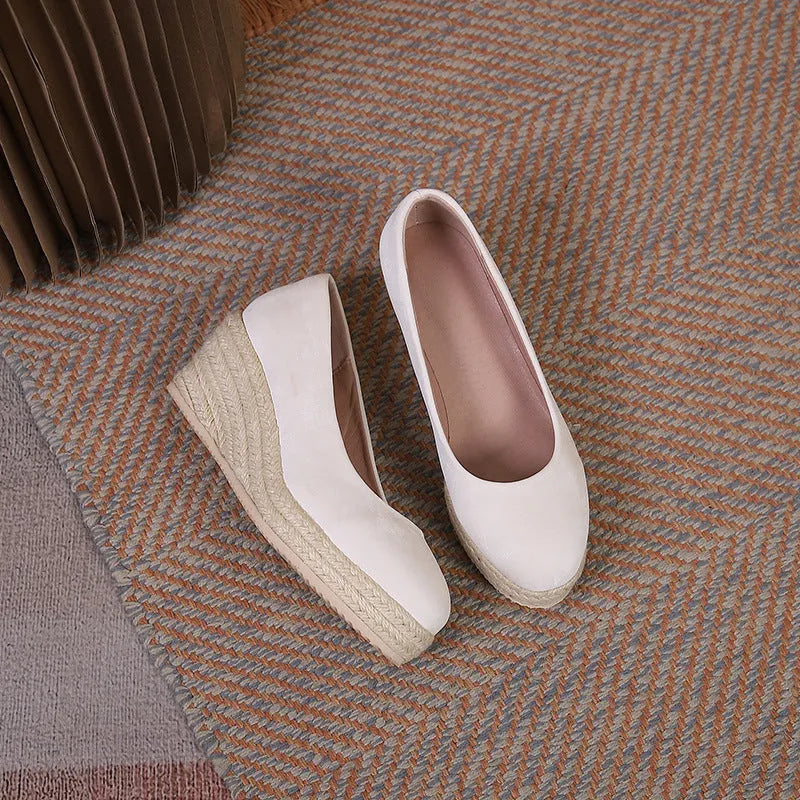 Apricot wedge heel pumps with a thick sole and rope-strap detail across the shallow mouth.