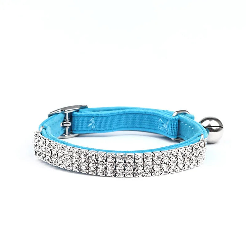 Velvet suede cat collar with rhinestone decoration in various colours on a white background.
