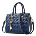 Women's large polyester messenger bag in black with shoulder strap and external pockets.