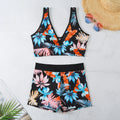 Women's two-piece printed swimsuit with high-neck top and boxer shorts in a multi-colour design.
