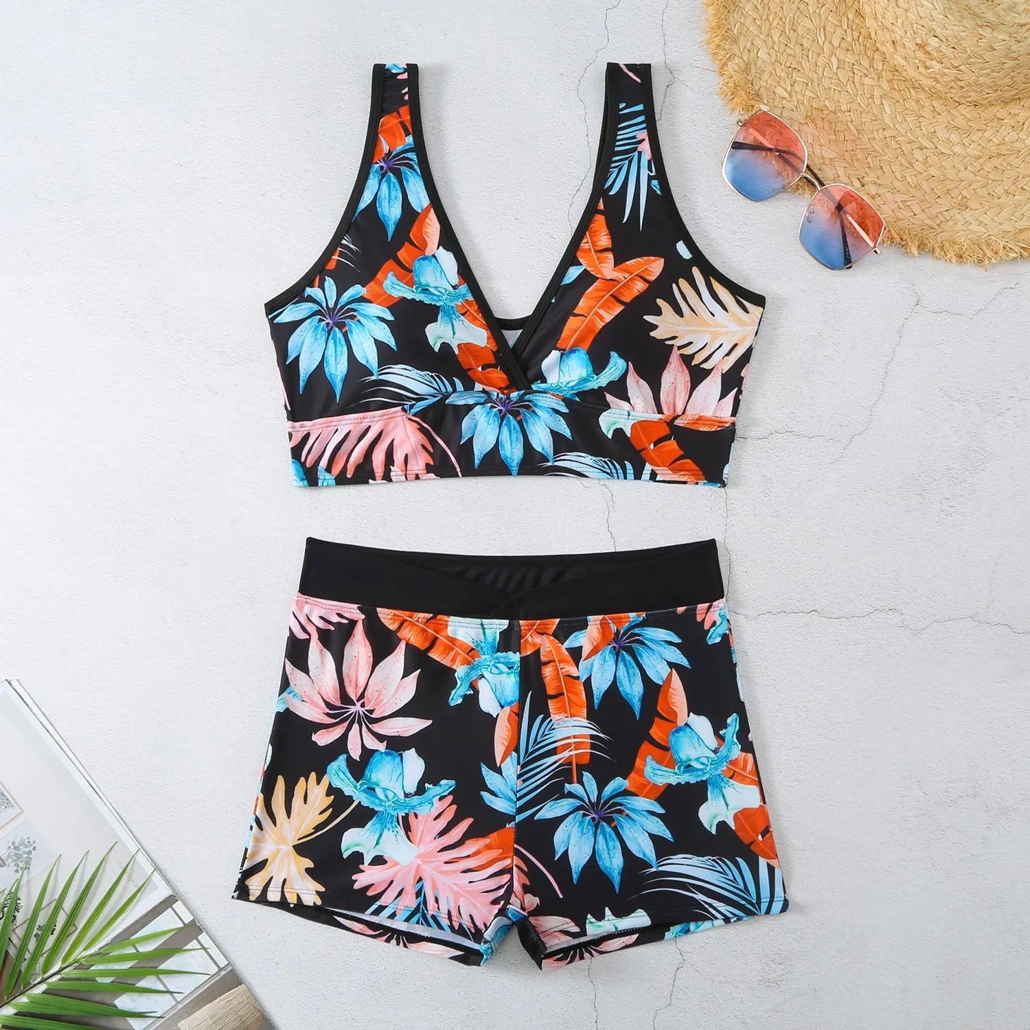 Women's two-piece printed swimsuit with high-neck top and boxer shorts in a multi-colour design.