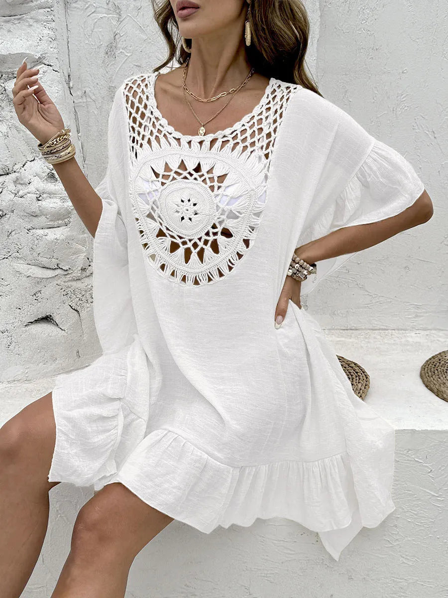 Crochet stitch detail on a patchwork skirt beach dress swimsuit cover-up in apricot colour.
