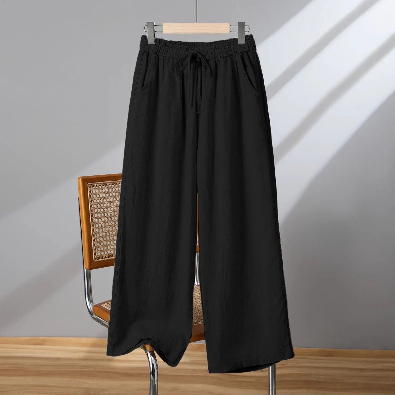 Women's apricot straight-leg casual trousers with an elastic lace-up waistband on a hanger.