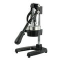 Black cast iron manual citrus juicer with stainless steel cone on a white background.