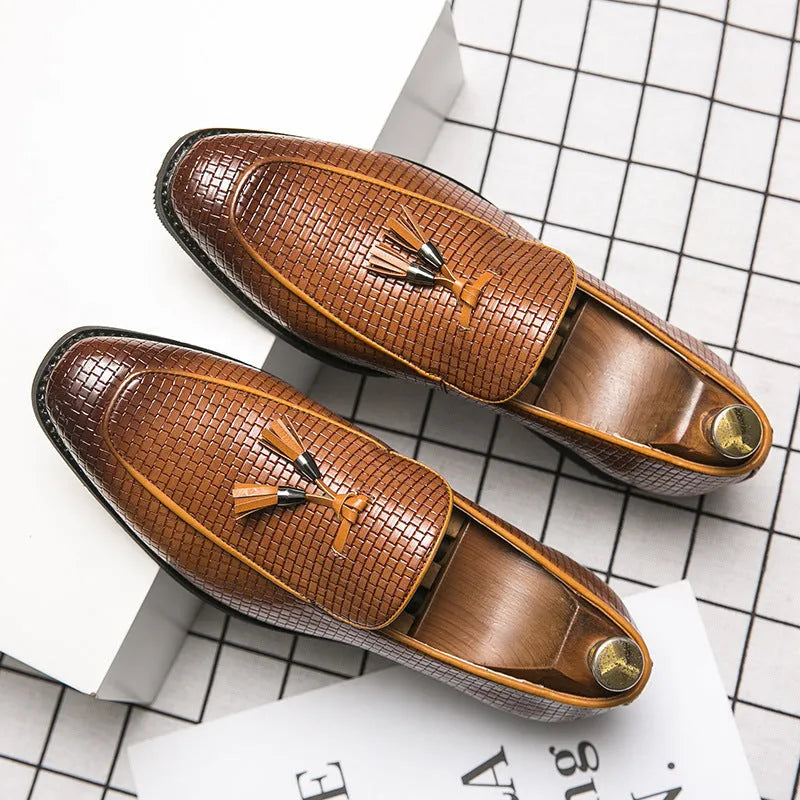 Men's black pointed toe slip-on business shoes with tassel detail on artificial PU leather upper