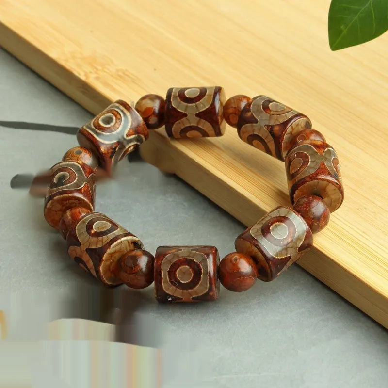 Agate Tibetan dzi bead bracelet with three-eye design and polished finish