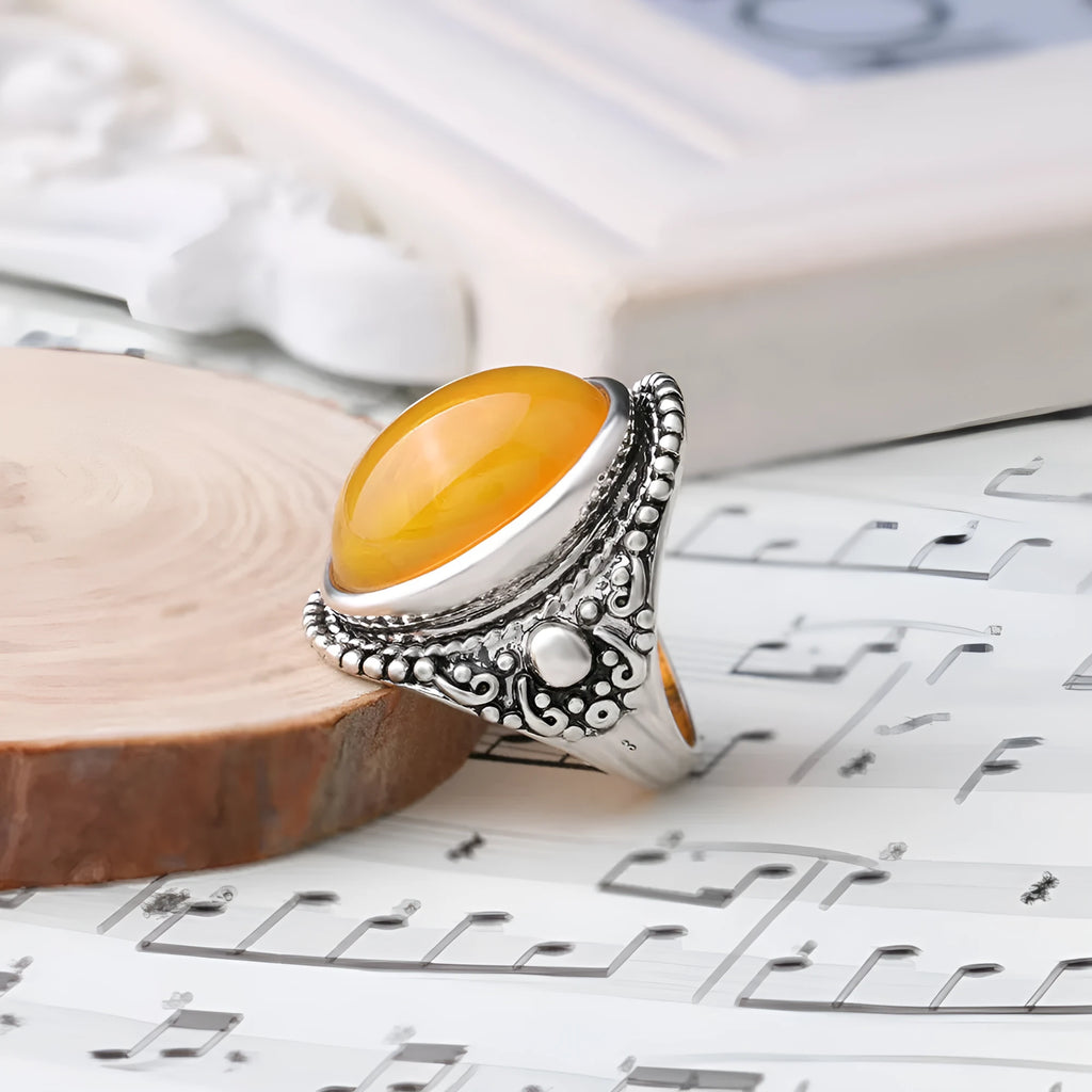 Close-up of a geometric retro ring in antique silver amber with a beeswax fluorescent finish.