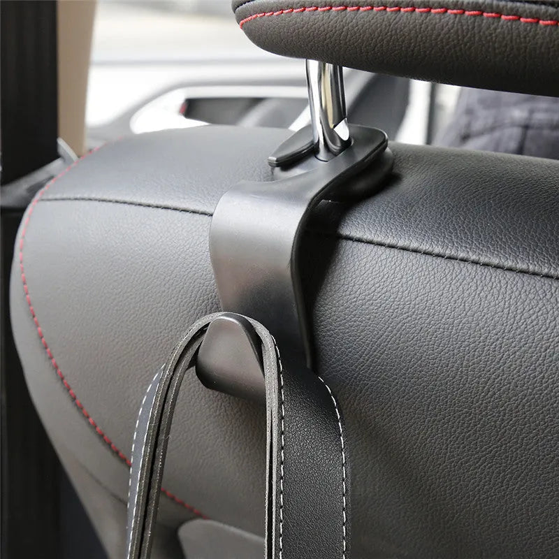 Set of 4 black PP universal car seat back hooks, each 11cm x 3.5cm, with 20kg weight capacity, for hanging bags from car front seat backs