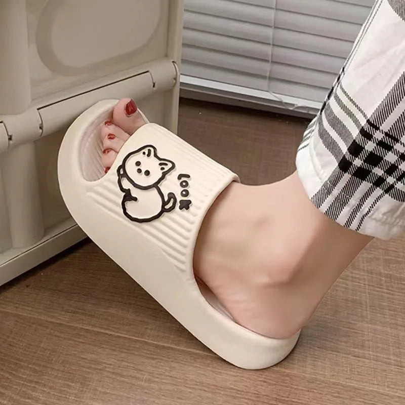Green cat design thick EVA platform slippers on a wooden floor