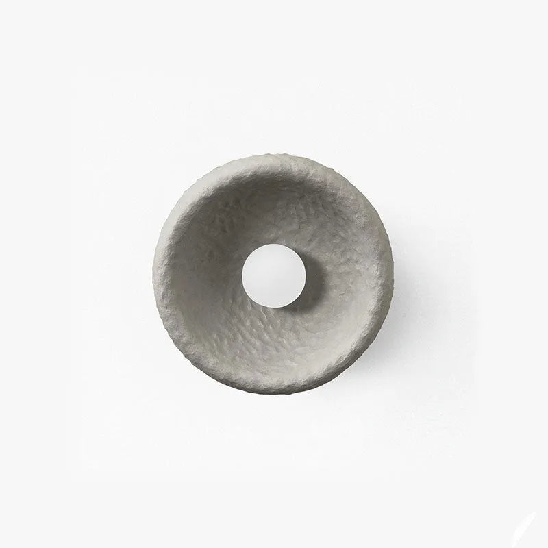 Japanese-style simple silent wall lamp with white resin shade on a wall.