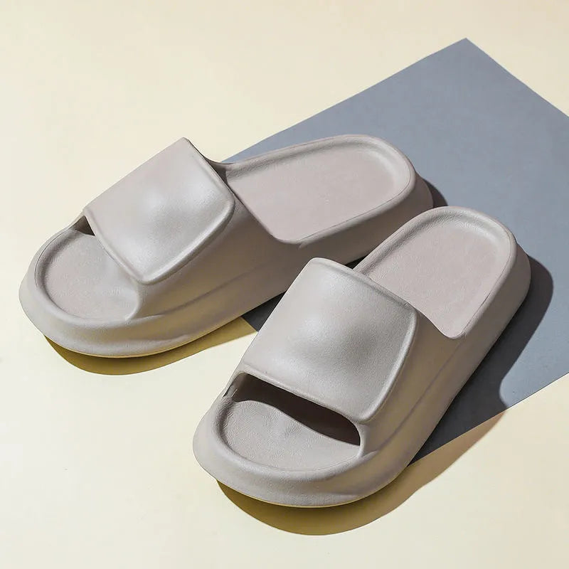 Pair of thick-soled EVA flip flop slippers in purple, showing deep sole profile.