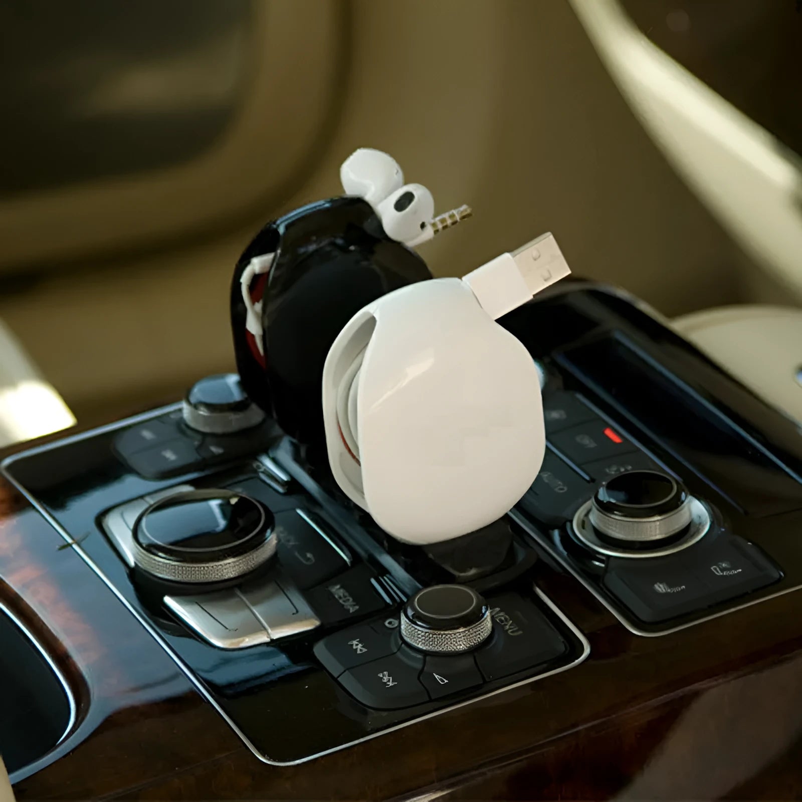 Automatic earphone retractor winder with telescopic reel and small storage box.
