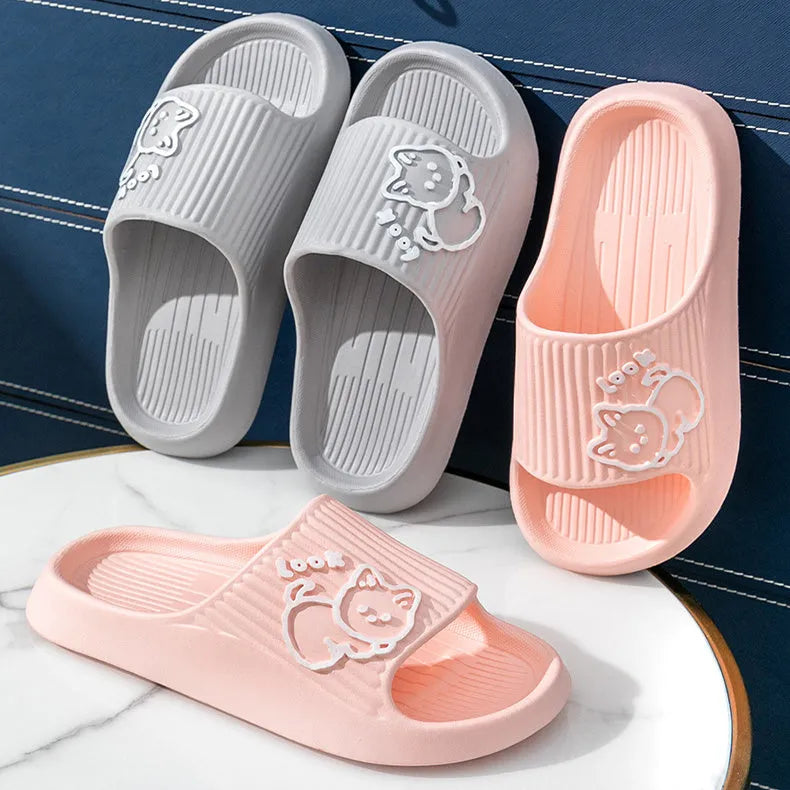 Green cat design thick EVA platform slippers on a wooden floor